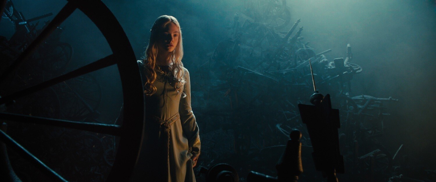 Elle Fanning as Aurora staring at the spindle in the movie "Maleficent" 
