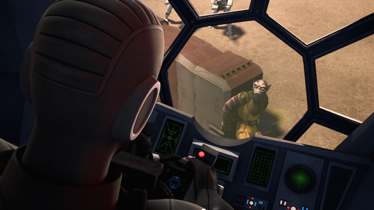 Zeb Orrelios looking into the cockpit of a TIE Fighter