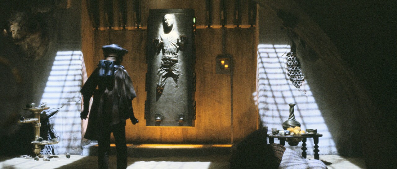 Later that night, Boushh enters the throne room and frees Solo from the carbonite. He is consciou...