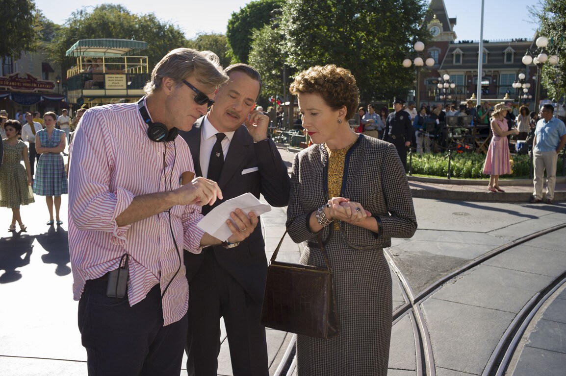 Actors Tom Hanks (as Walt Disney) and Emma Thompson (as P.L. Travers) with director John Lee Hancock behind-the-scenes in the movie "Saving Mr. Banks".