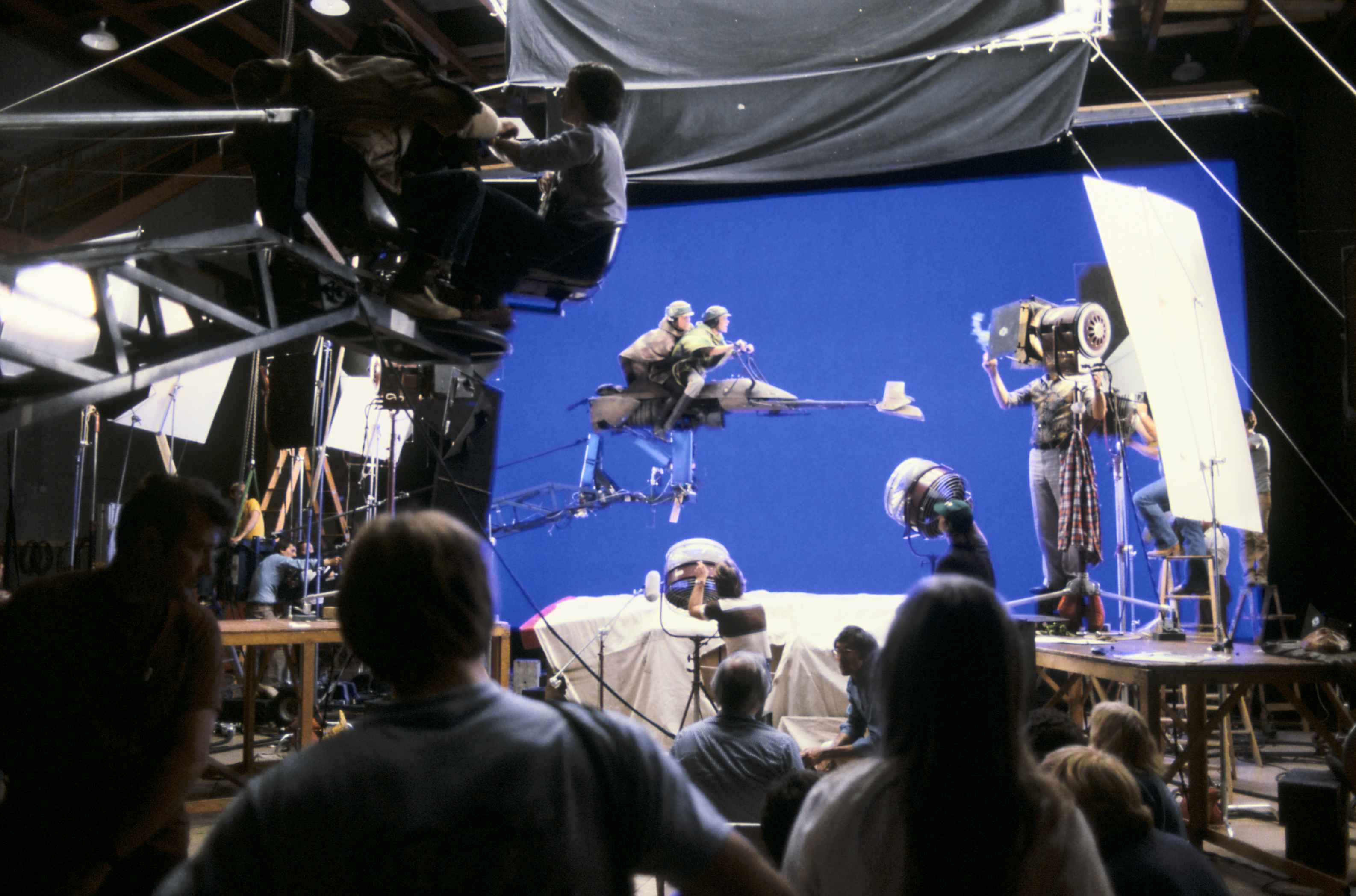 Mark Hamill and Carrie Fisher sit atop a speeder bike prop, with backgrounds to be added later vi...