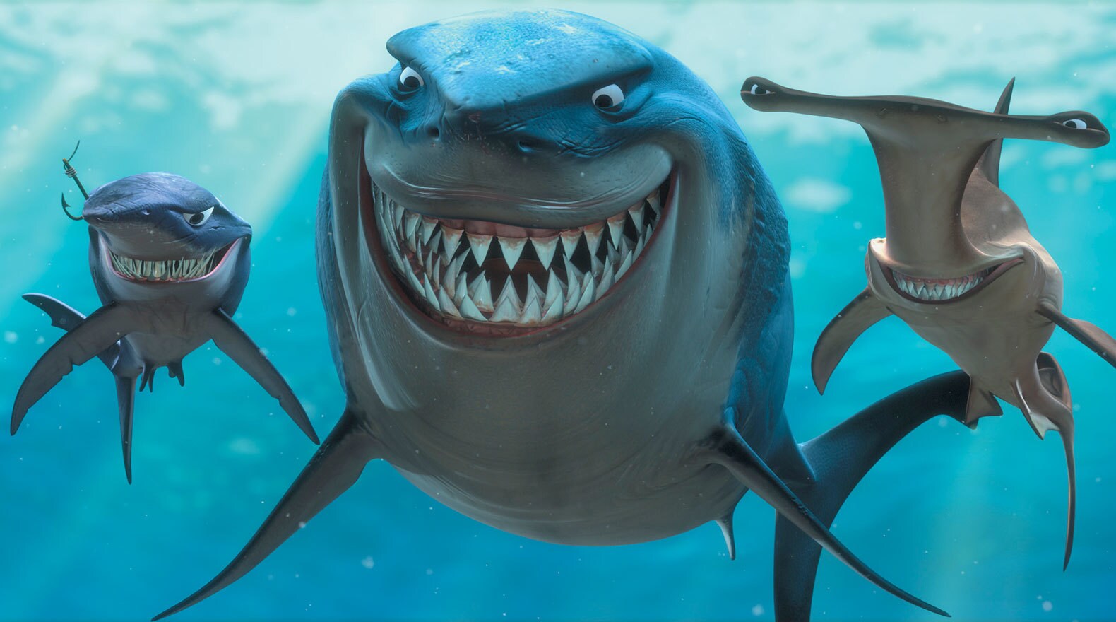 Shark characters Bruce, Anchor, and Chum in a line smiling in "Finding Nemo"