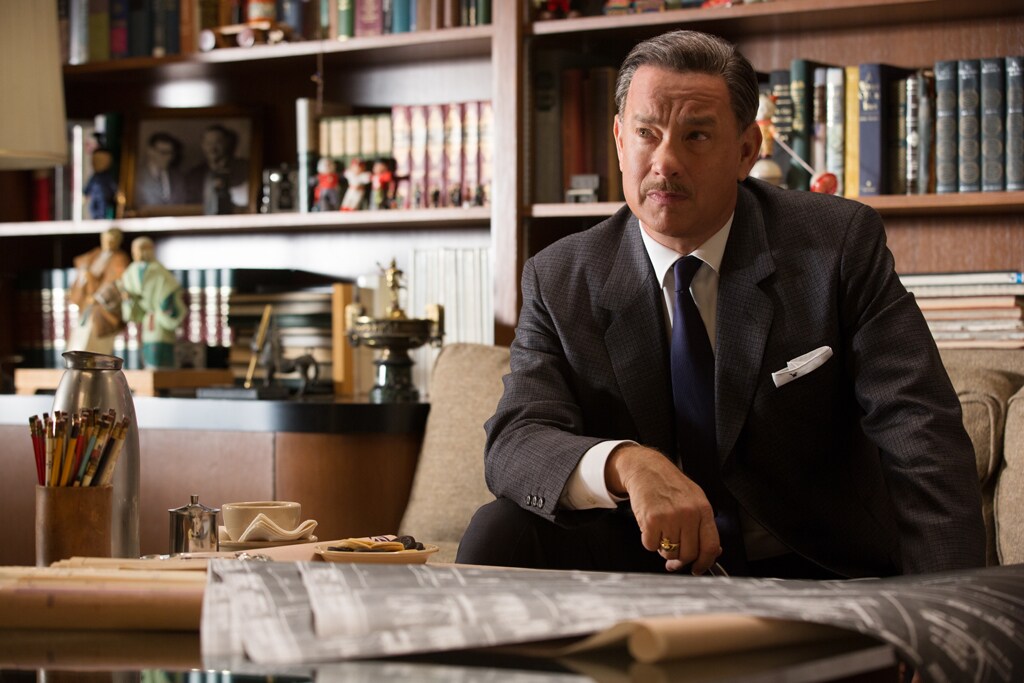 Actor Tom Hanks as Walt Disney sitting on a couch in the movie "Saving Mr. Banks".