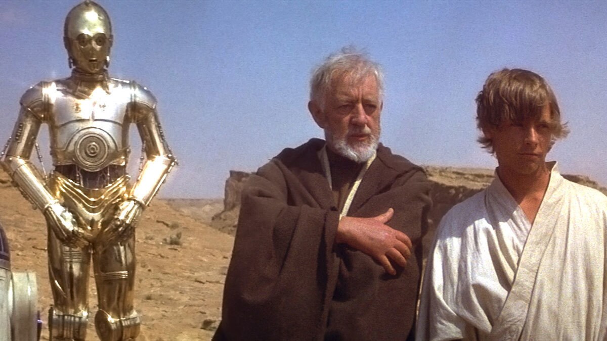 Obi-Wan Kenobi, Luke Skywalker, C-3PO, and R2-D2 overlooking Mos Eisley