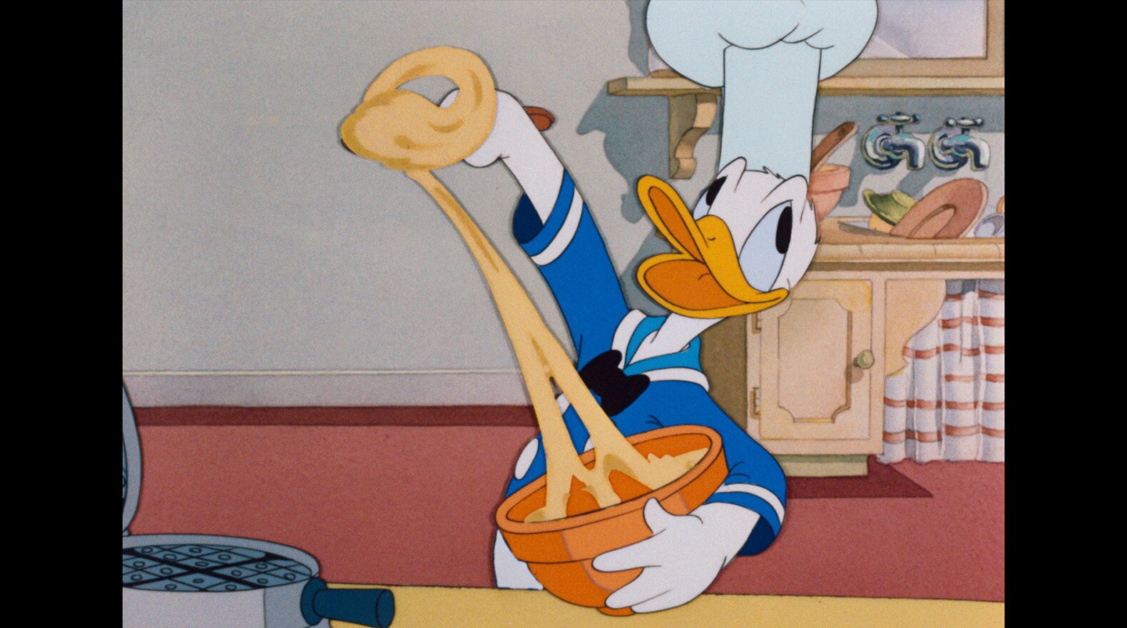 Donald tries his hand at cooking while listening to a radio show.