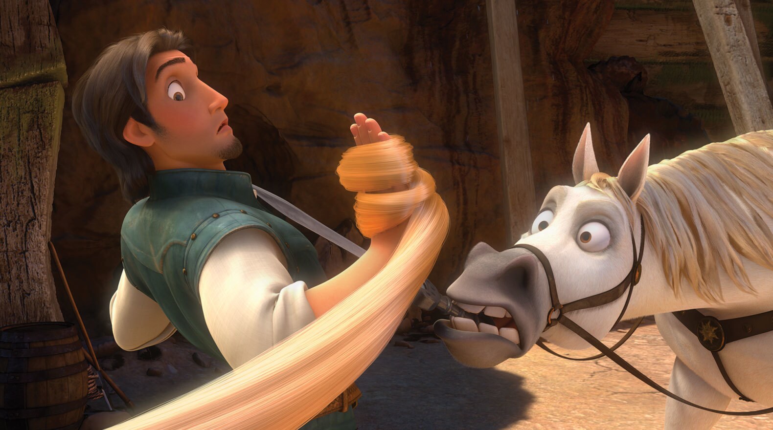 Flynn Rider and Maximus (horse) look at hair wrapped on Flynn's hand