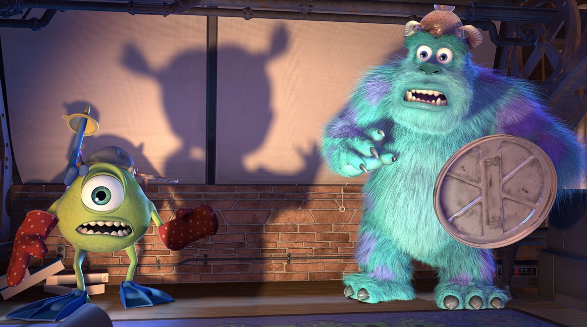 Billy Crystal as Mike Wazowski and John Goodman as Sully and a shadow of Boo projected on a wall in Monters, Inc.