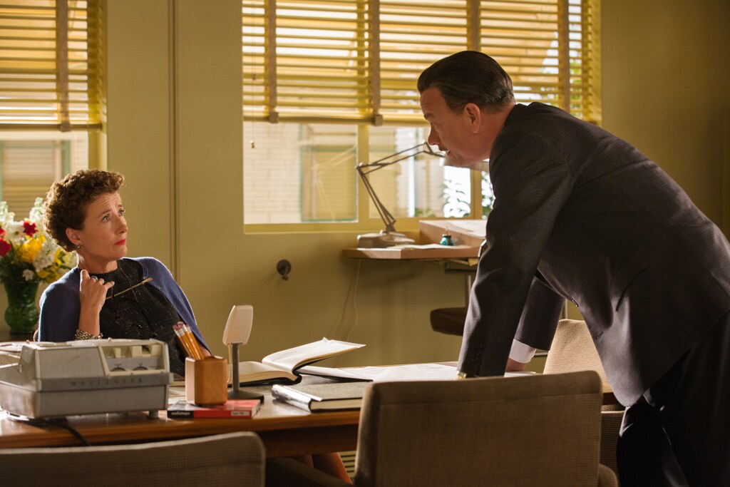 Actors Tom Hanks (as Walt Disney) and Emma Thompson (as P.L. Travers) at a desk in the movie "Saving Mr. Banks".