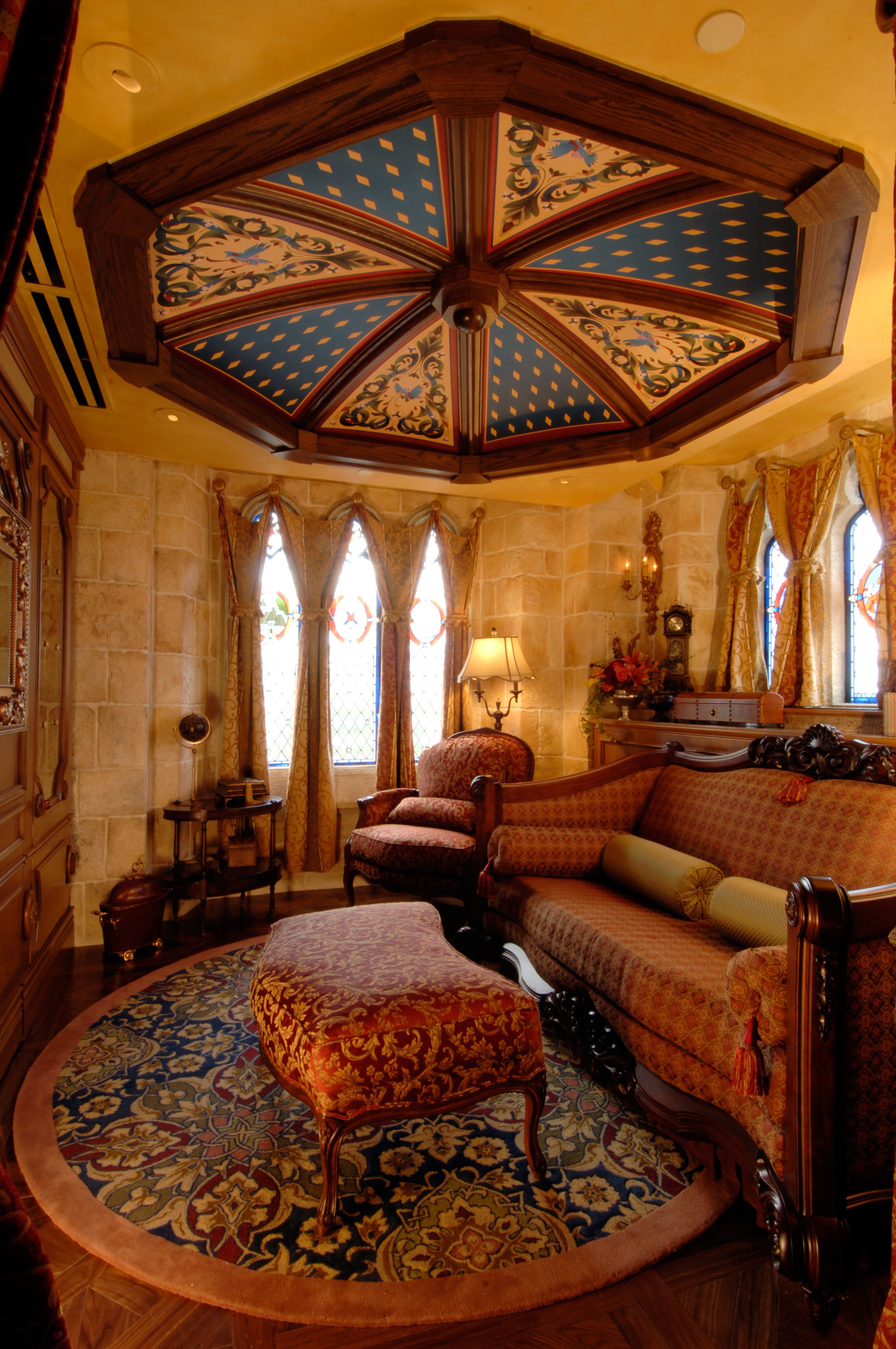 The sitting room inside the Cinderella Castle Suite is anchored by a custom sofa bed – a one-of-a...