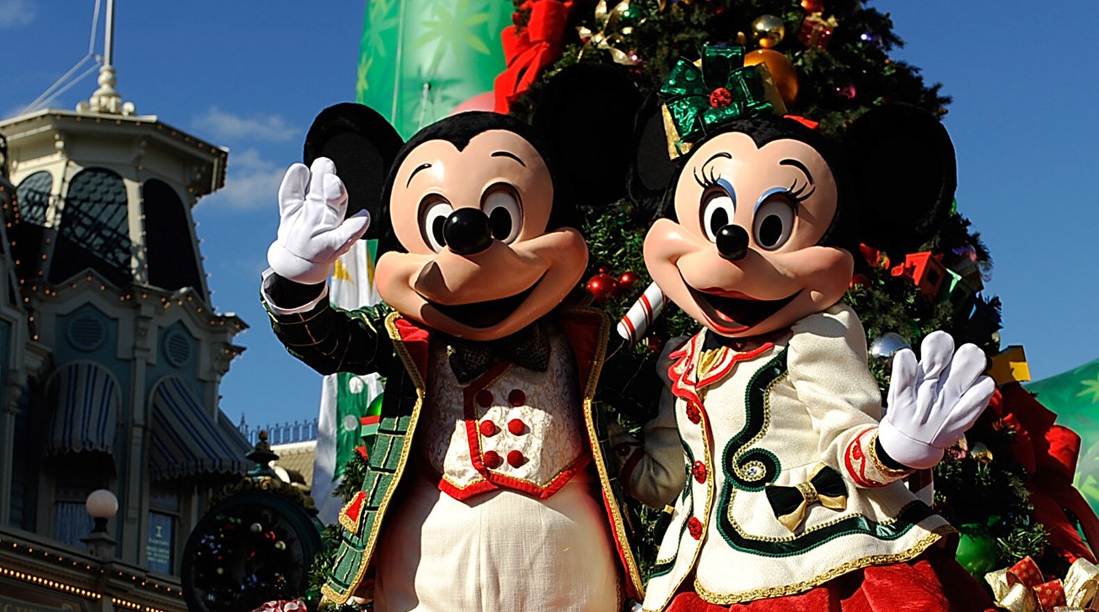 A festive Minnie and Mickey Mouse greet the crowd from aboard their float at The Disney Parks Chr...