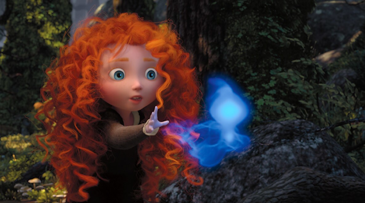 A young Merida, voiced by Peigi Barker, reaching for a blue Wisp in the movie Brave