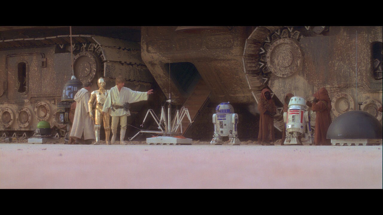 C-3PO, R2-D2 and other droids are presented for sale by the Jawas and examined by Luke Skywalker.