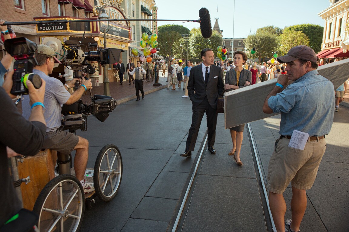Actors Tom Hanks (as Walt Disney) and Emma Thompson (as P.L. Travers) walk down Main Street while shooting at Disneyland in the movie "Saving Mr. Banks".