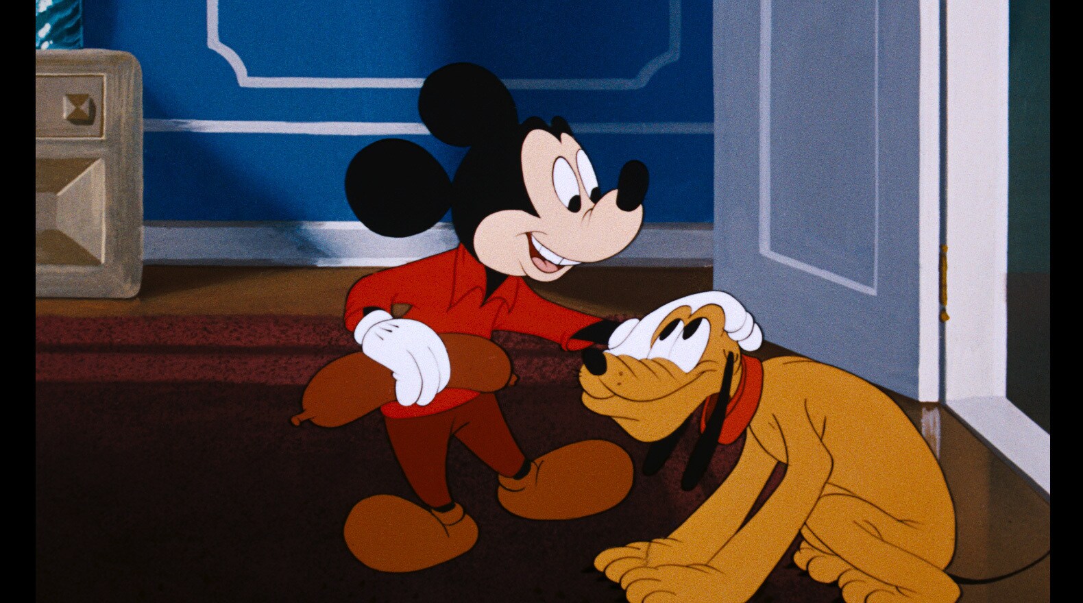 Pluto brings Mickey back a treat from the butcher store.