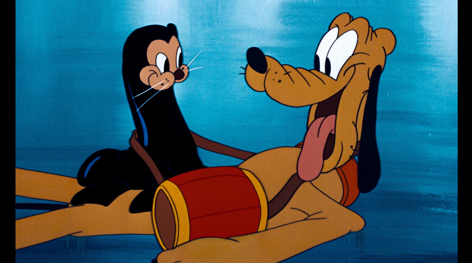 Pluto spends some quality time with the seal that Mickey asks him to guard.