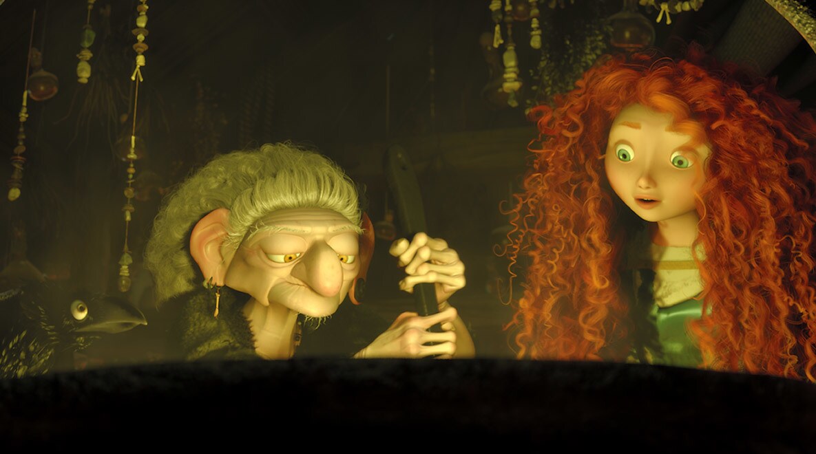 Merida, voiced by Kelly Macdonald, with The Witch, voiced by Julie Walters, who is stirring a potion in a cauldron in the movie Brave