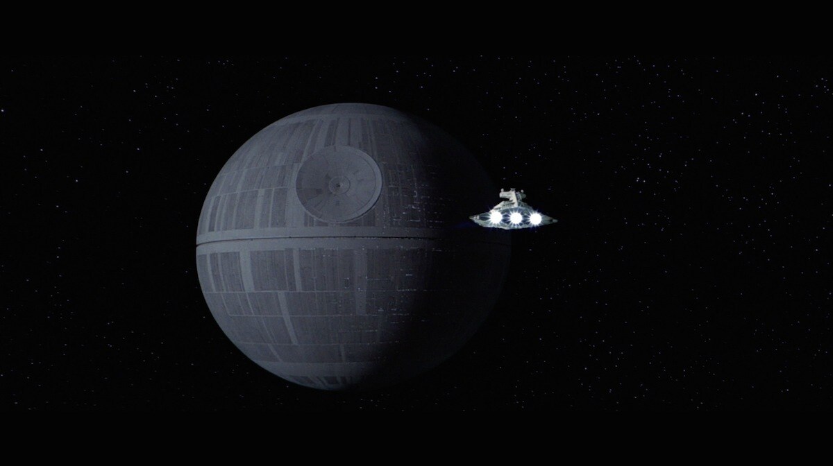 An Imperial Star Destroyer approaching the Death Star 