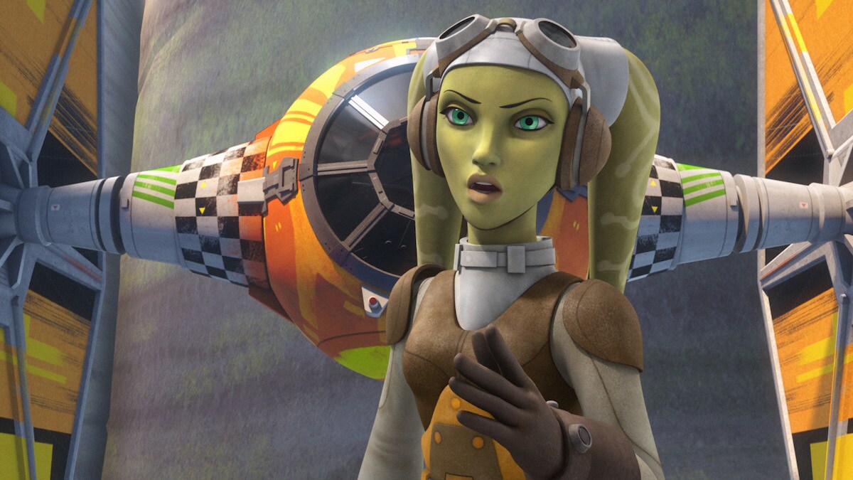 Hera Syndulla standing in front of a customized TIE Fighter
