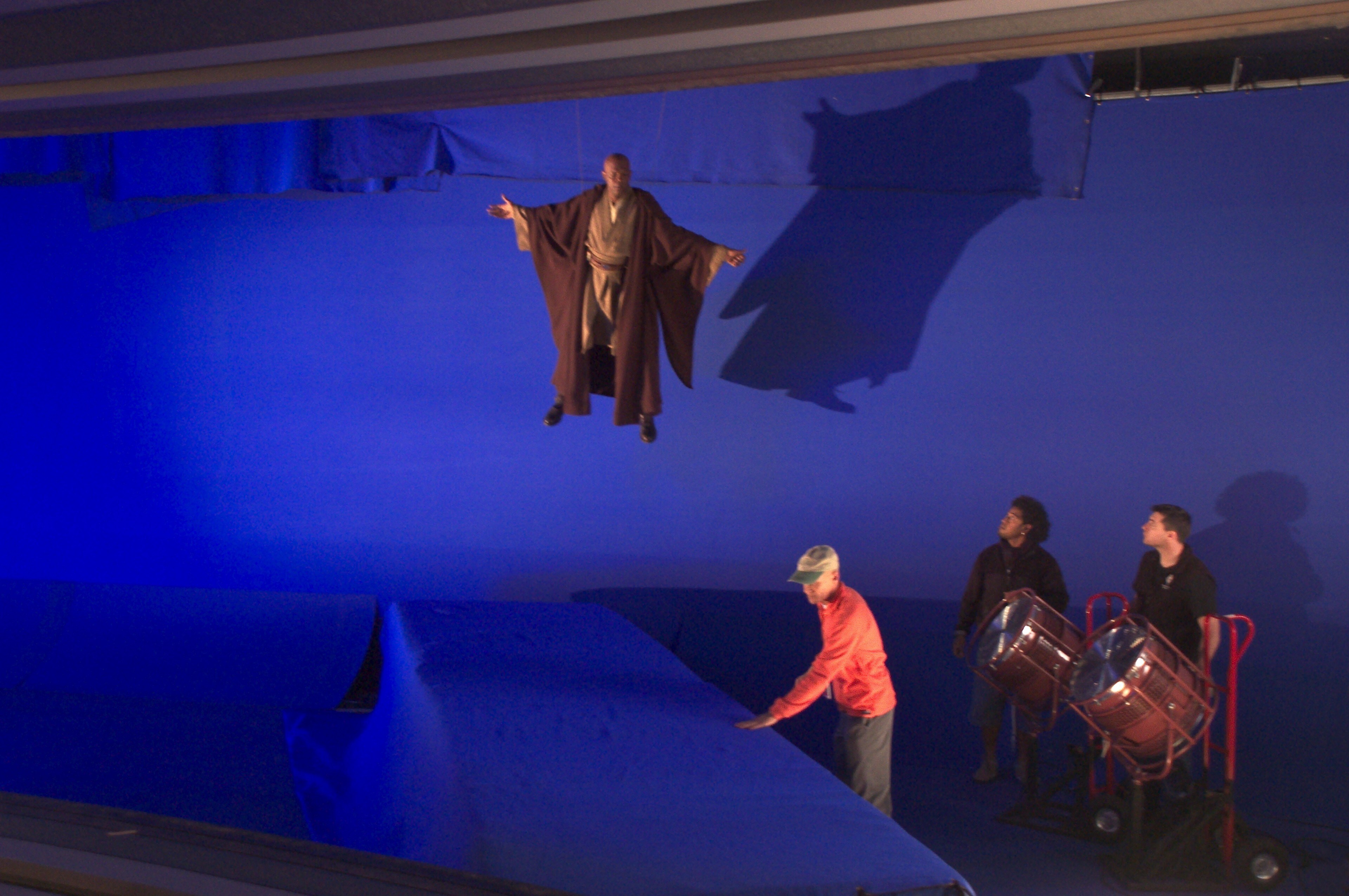Samuel L. Jackson, suspended by wires, on a blue-screen set for Mace Windu's duel with Darth Sidi...