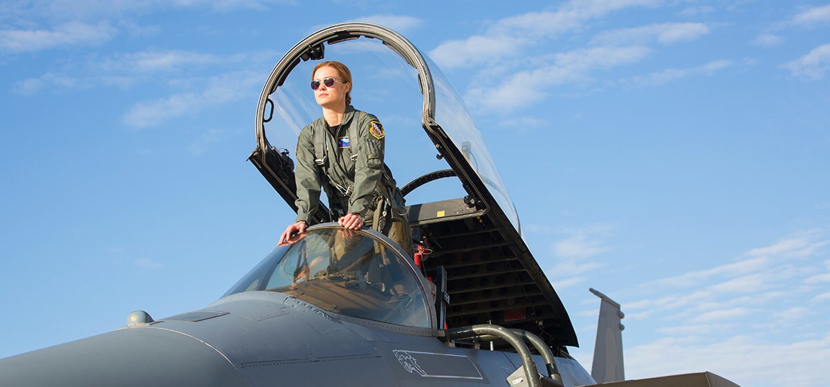 Brie Larson (Carol Danvers) standing on the seat of a fighter jet in Marvel Studios' Captain Marvel