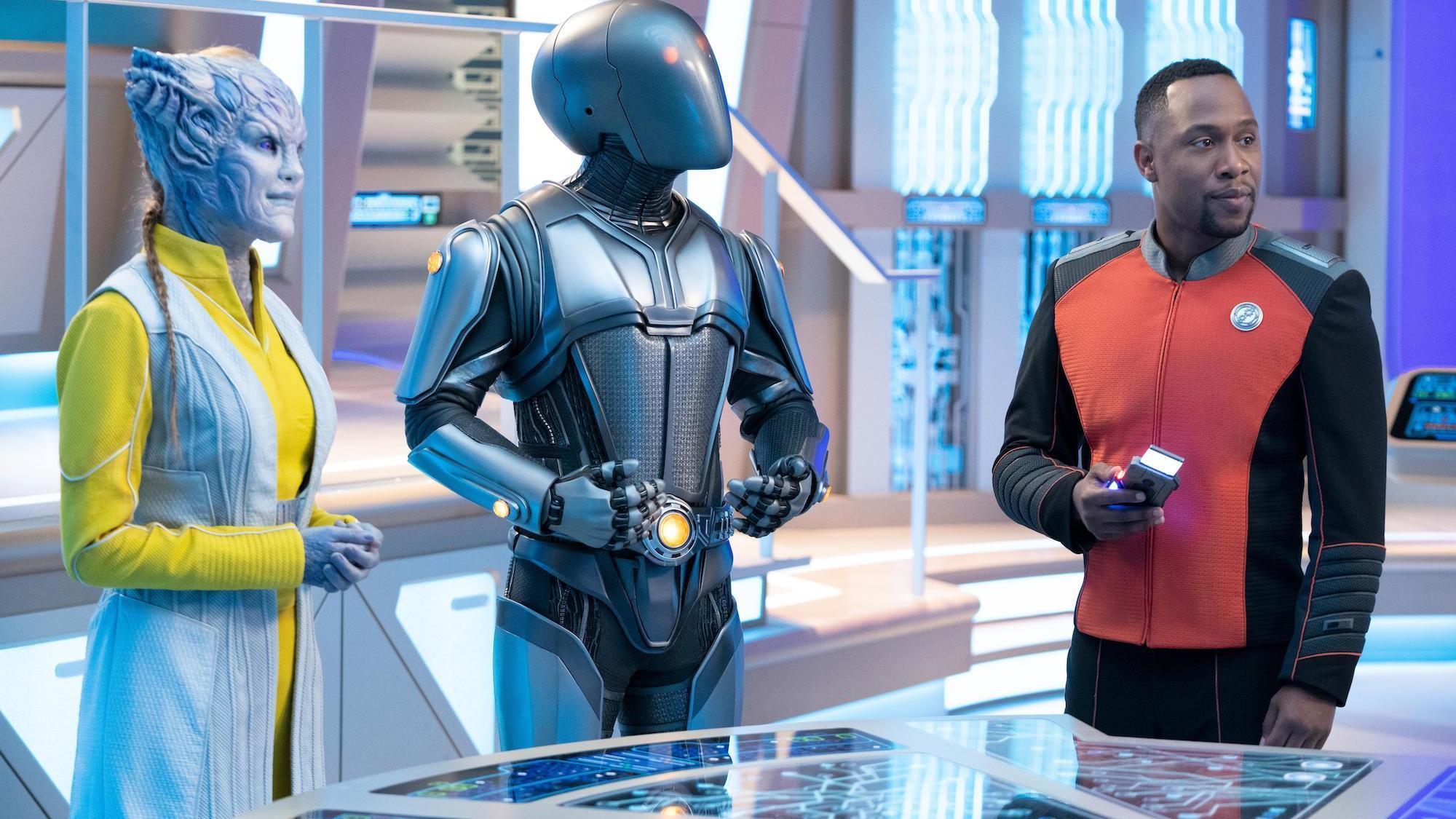 The Orville: New Horizons -- “From Unknown Graves” - Episode 307 -- The Orville discovers a Kaylon with a very special ability. Dr. Villka (Eliza Taylor), Isaac (Mark Jackson) and Lt. Cmdr. John LaMarr (J Lee), shown. (Photo by: Greg Gayne/Hulu)