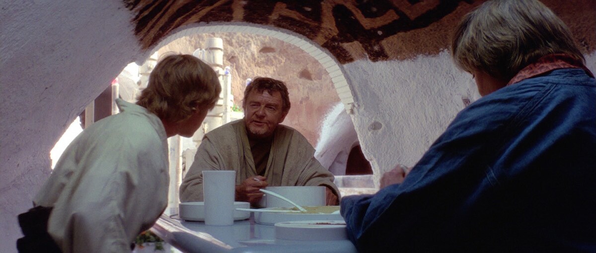 Owen Lars sharing a meal with Luke Skywalker and Beru