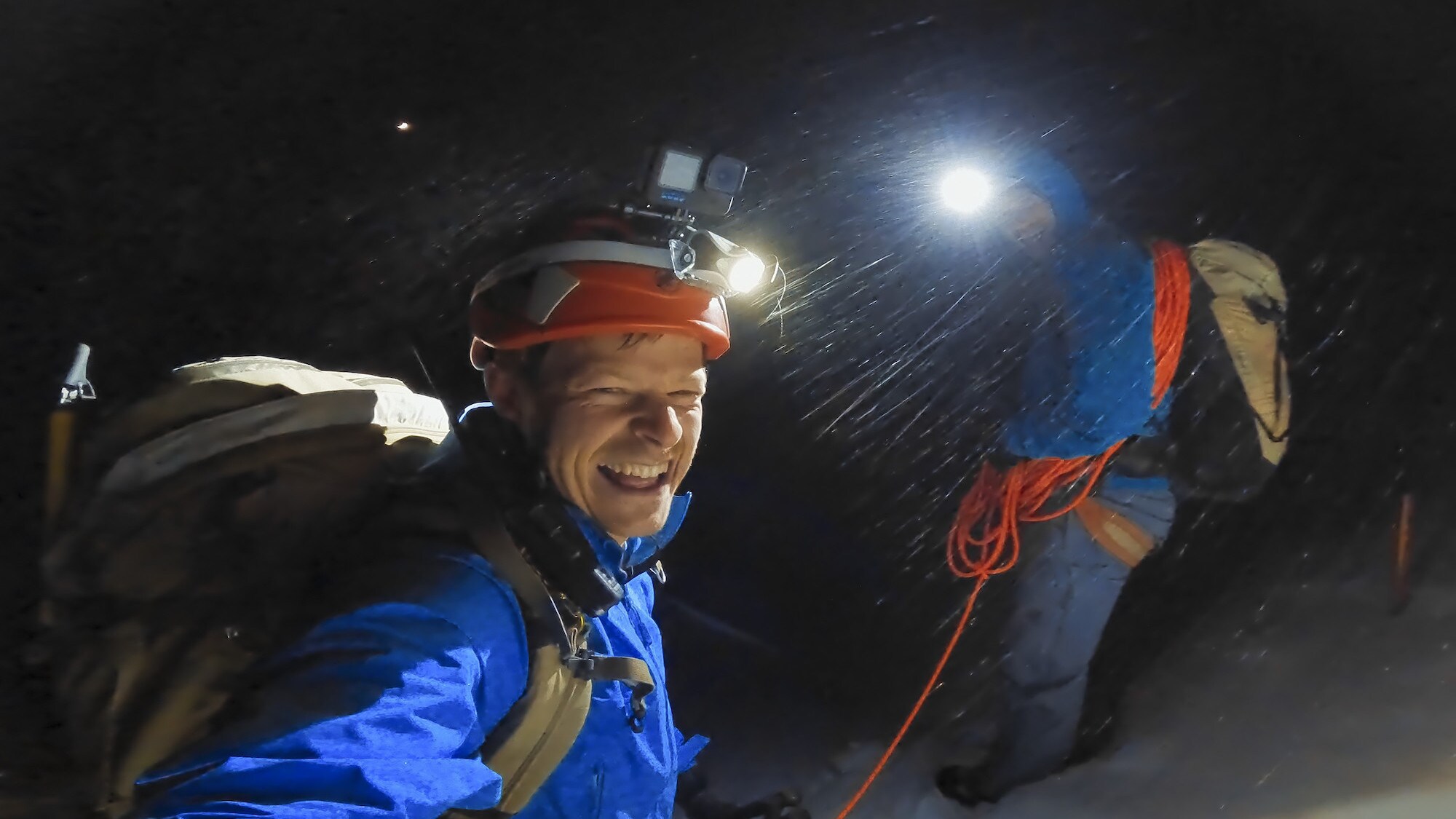 Bertie Gregory laughing at the camera during a night climb. (National Geographic for Disney+/Bertie Gregory)