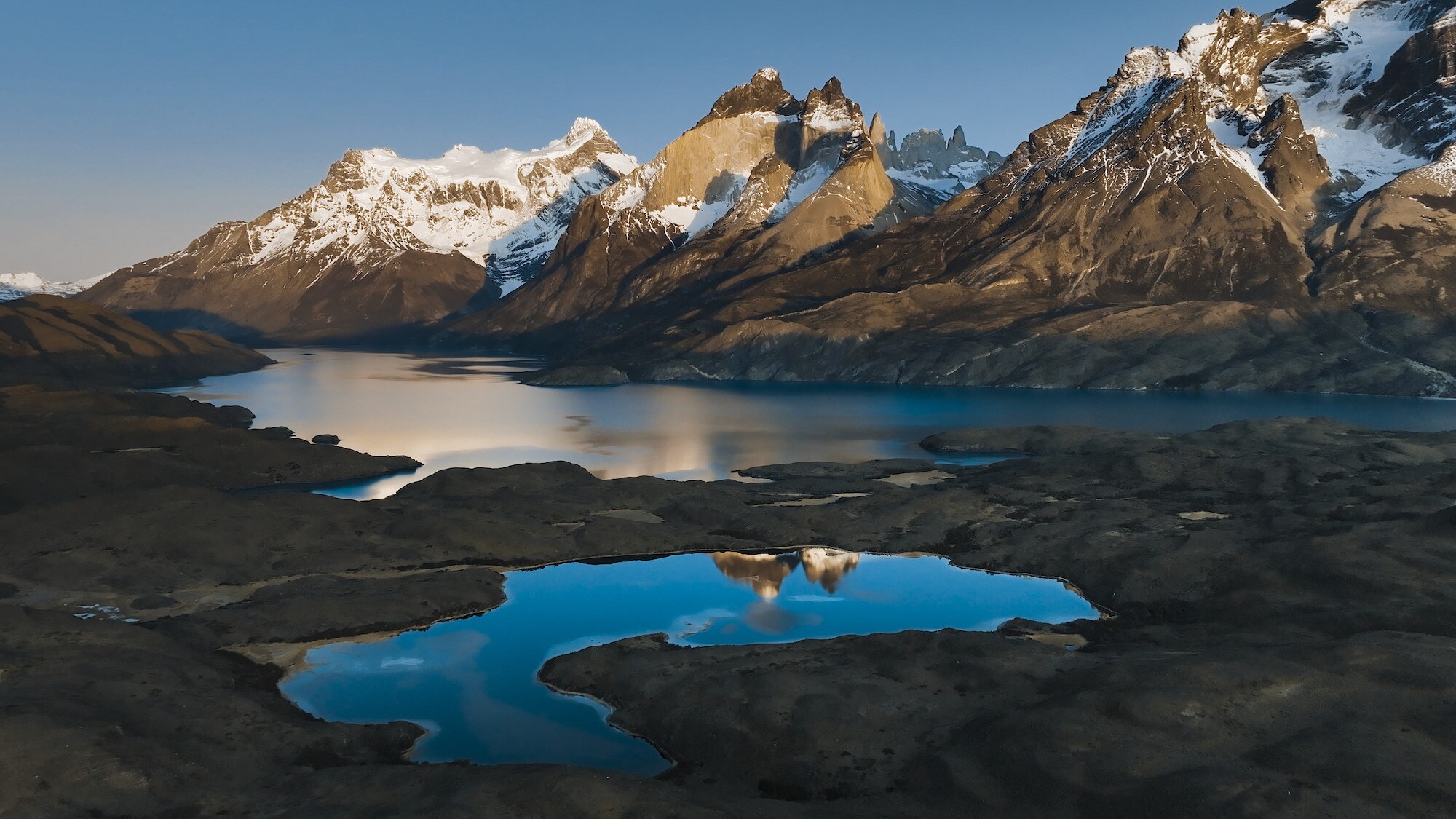 Mountains reflected in the water. (National Geographic for Disney+/Sam Stewart)