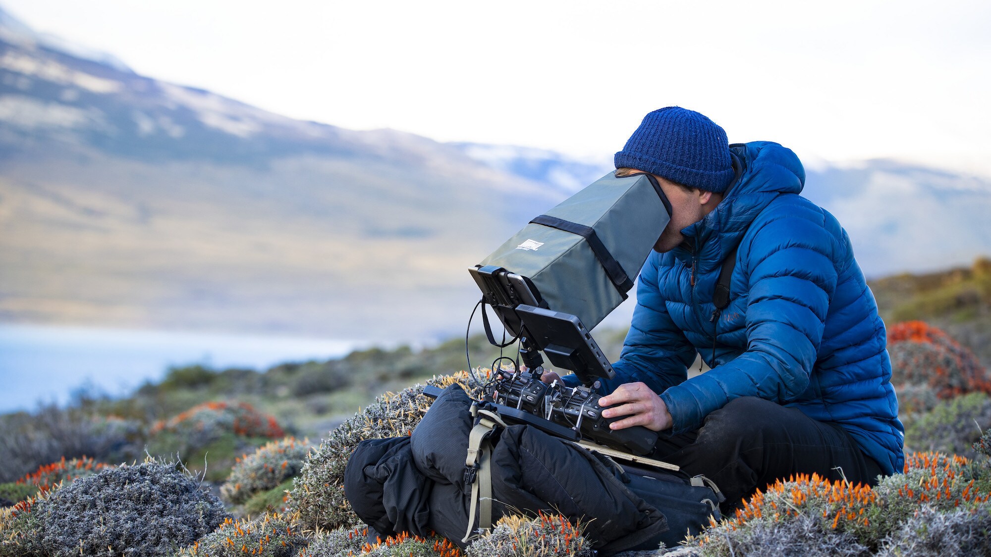 Bertie Gregory viewing the drone through a monitor in Patagonia. (National Geographic for Disney+/Anna Dimitriadis)