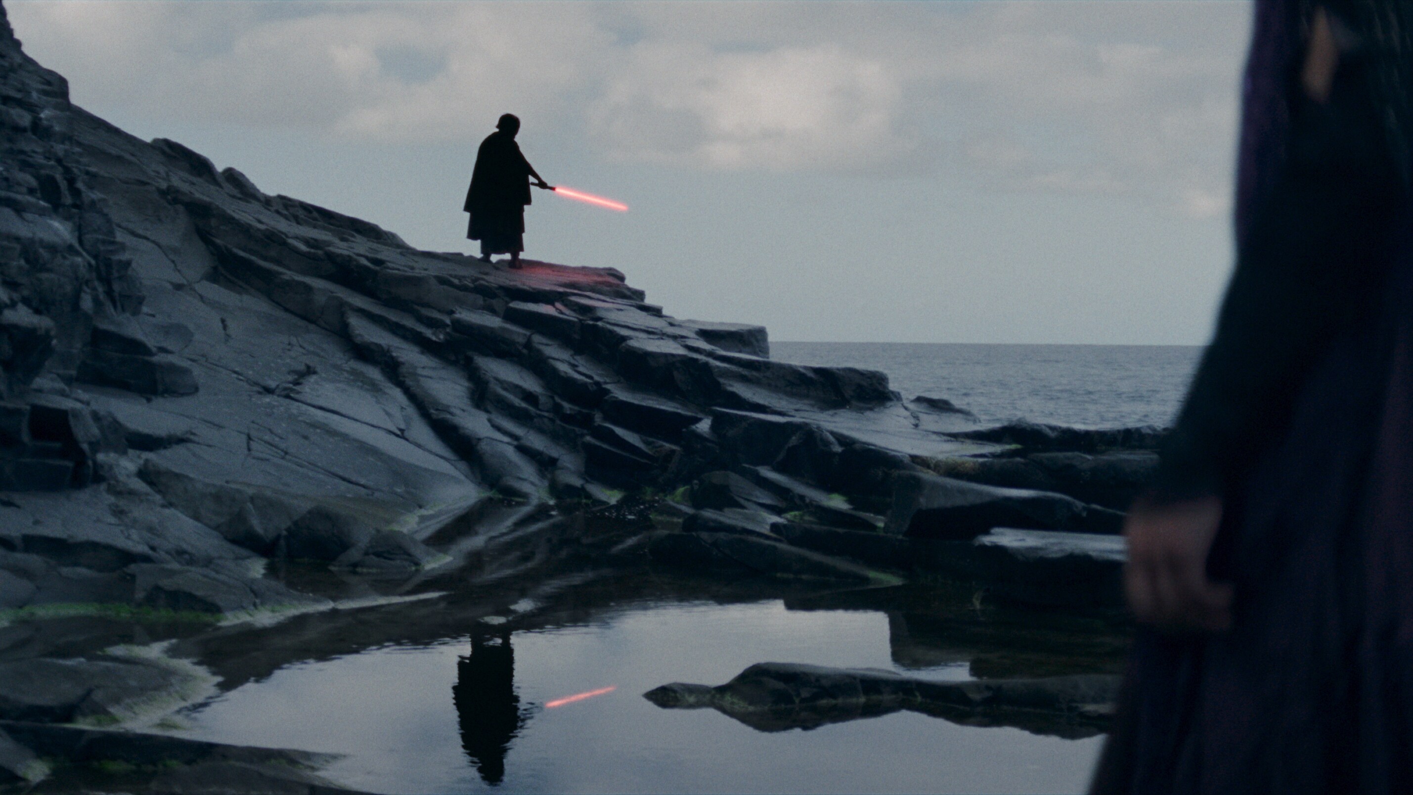 Establishing shot featuring red lightsaber in the Acolyte 