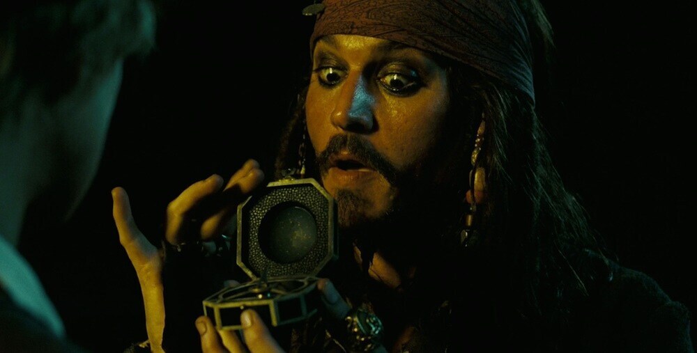 Actor Johnny Depp as Captain Jack Sparrow holding a compass