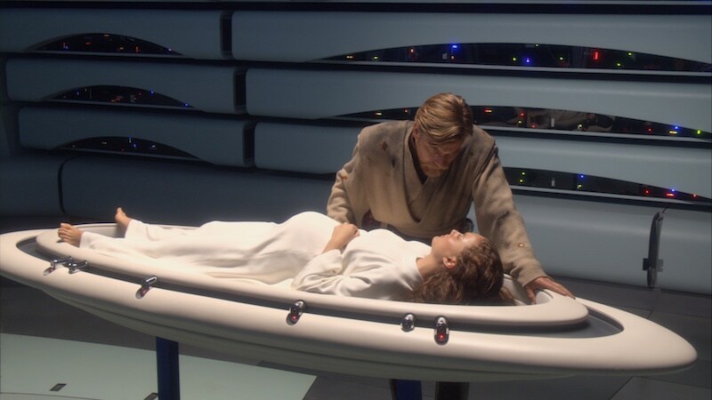 Obi-Wan Kenobi standing at Padme Amidala's side during childbirth