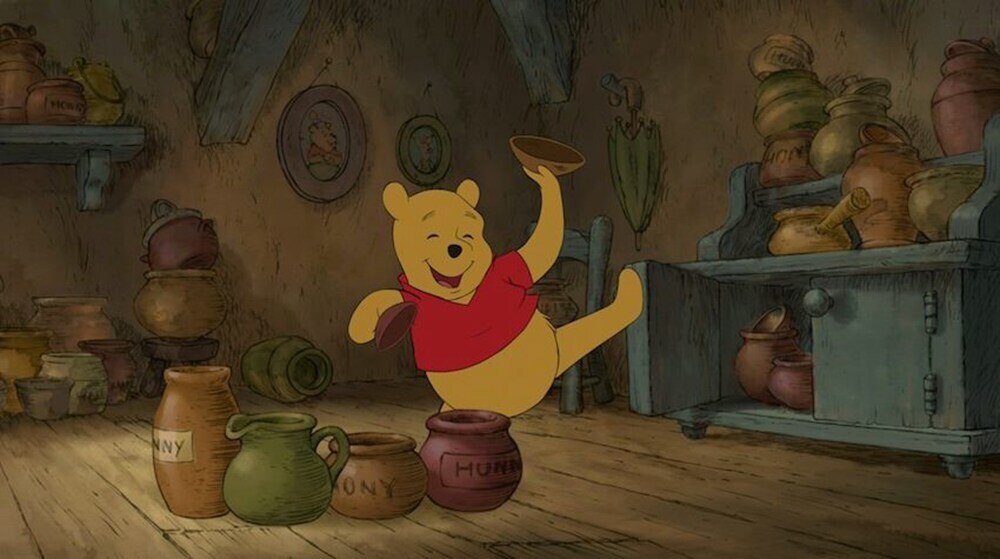Winnie the Pooh dancing with a bowl in his hand