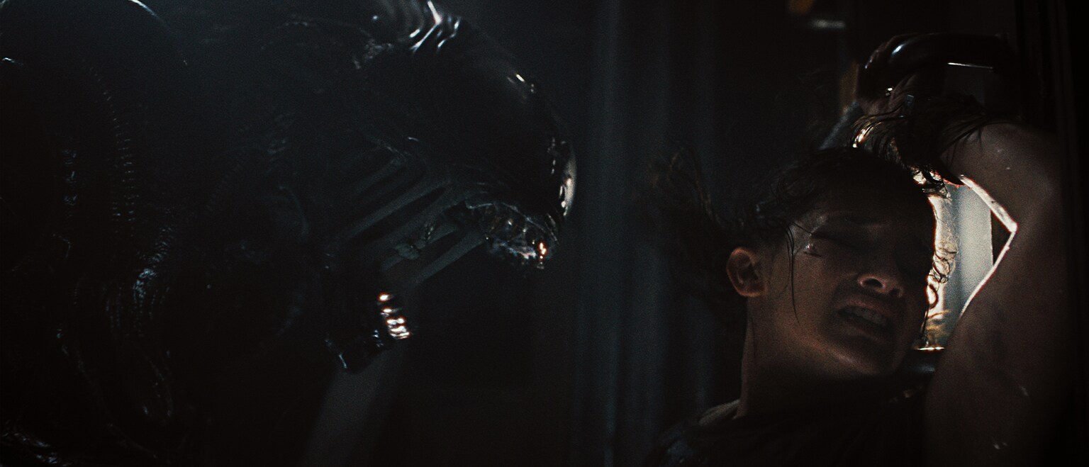 (L-R): Xenomorph and Cailee Spaeny as Rain Carradine in 20th Century Studios' ALIEN: ROMULUS. Photo courtesy of 20th Century Studios. © 2024 20th Century Studios. All Rights Reserved.