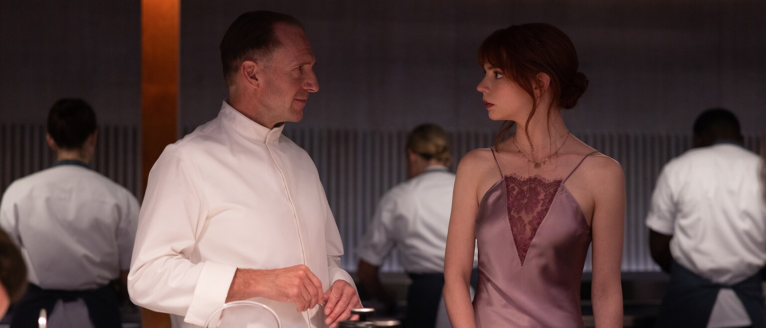 Chef Slowik (actor Ralph Fiennes) talks with Margo (actor Anya Taylor-Joy) from the Searchlight Pictures movie, "The Menu".