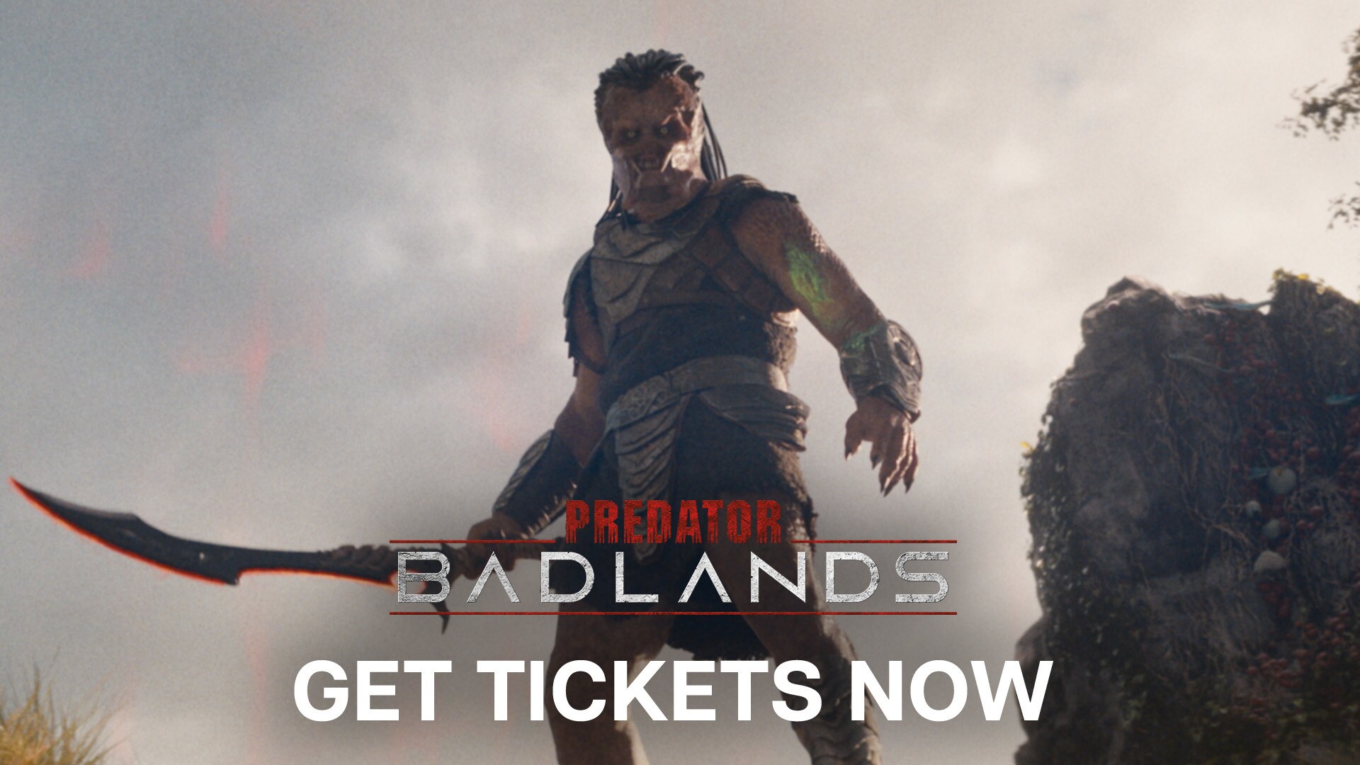 Image of Dek (Dimitrius Schuster-Koloamatangi) holding a large bladed weapon. | Predator: Badlands | Get tickets now.
