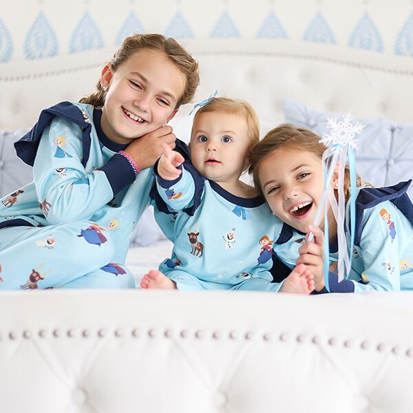 Three kids pose in Monica + Andy Frozen Collection pajamas.