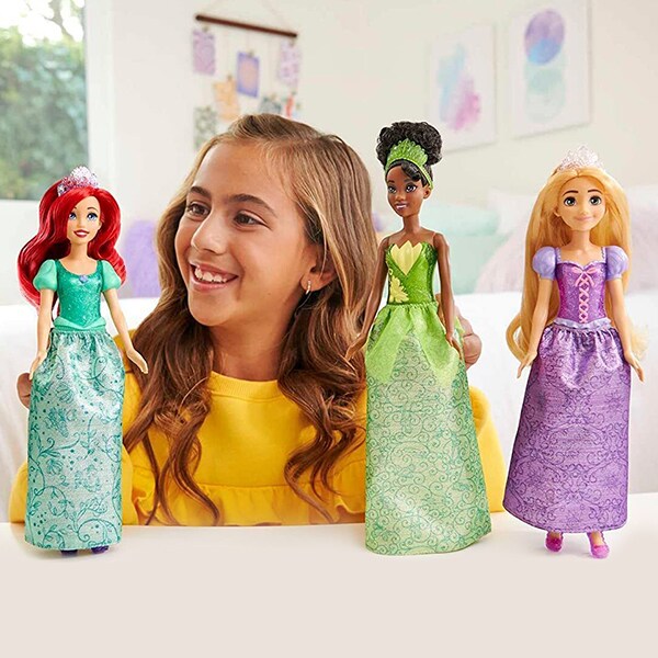 Disney Princess Fashion Dolls product image featuring a girl playing with Ariel, Tiana, and Rapunzel dolls.