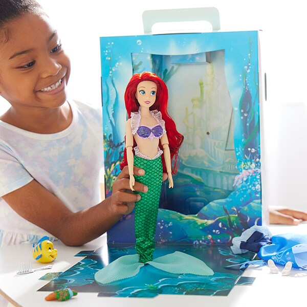 Image of a girl playing with an Ariel doll from the Disney Story Doll collection.