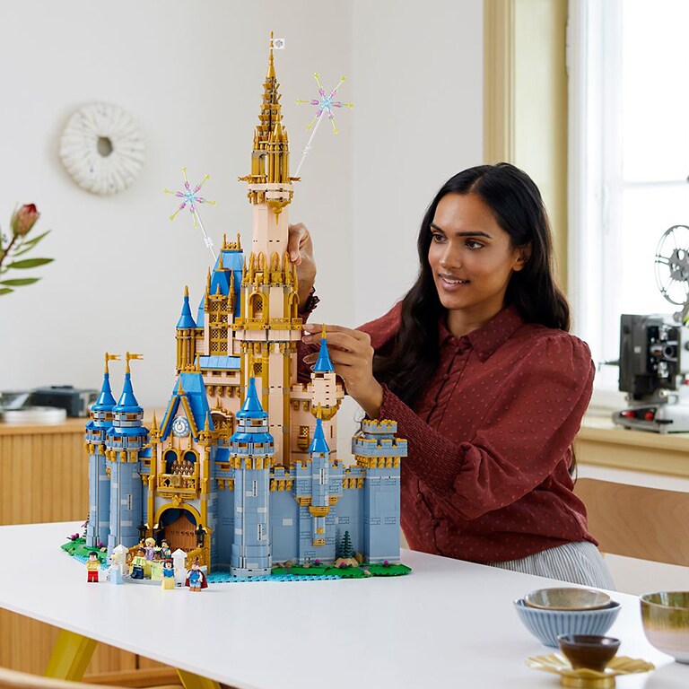 Image of a woman building the LEGO Disney100 Castle