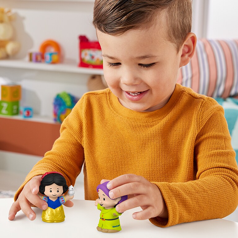 A child plays with a Rapunzel and Pascal Little People Story Duos Figures.