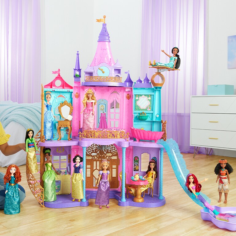 Photo of a girl playing with Disney Princess dolls and a Magical Adventures Castle.