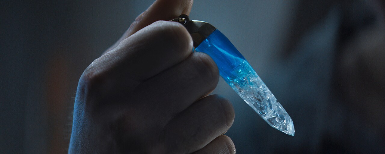 Cassian Andor holding a kyber crystal.