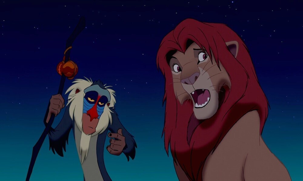 Rafiki (the baboon) talking to Simba (the lion) in the animated movie "The Lion King"