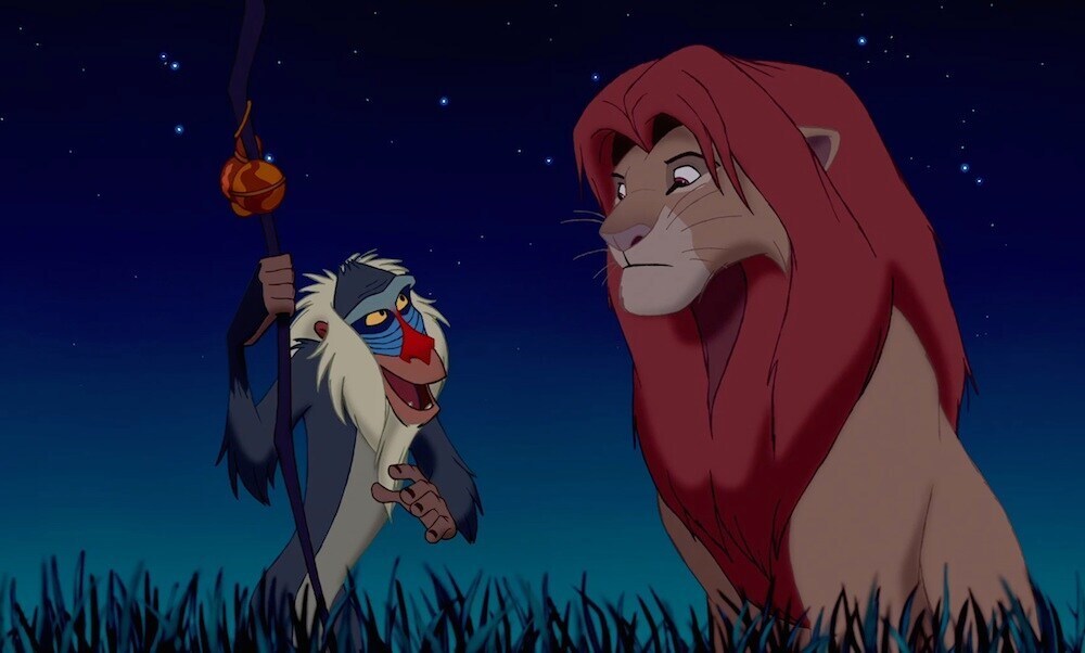 Rafiki (the baboon) talking to Simba (the lion) in the animated movie "The Lion King"