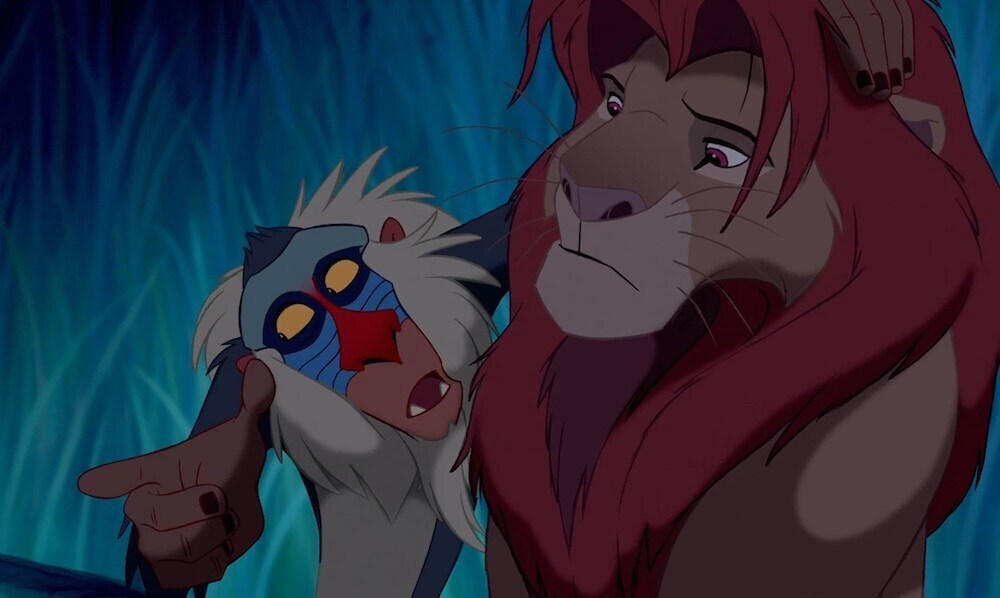 Rafiki (the baboon) talking to Simba (the lion) in the animated movie "The Lion King"