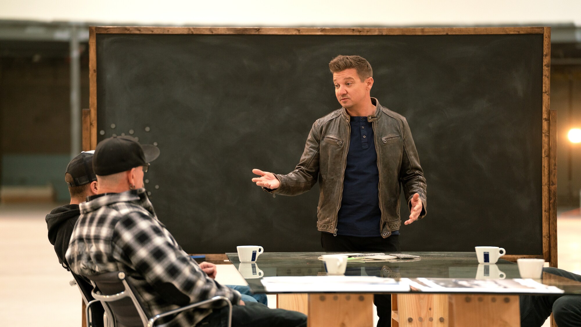 Jeremy Renner speaks with the build team on Disney's RENNERVATIONS. (Disney/Nina Riggio)