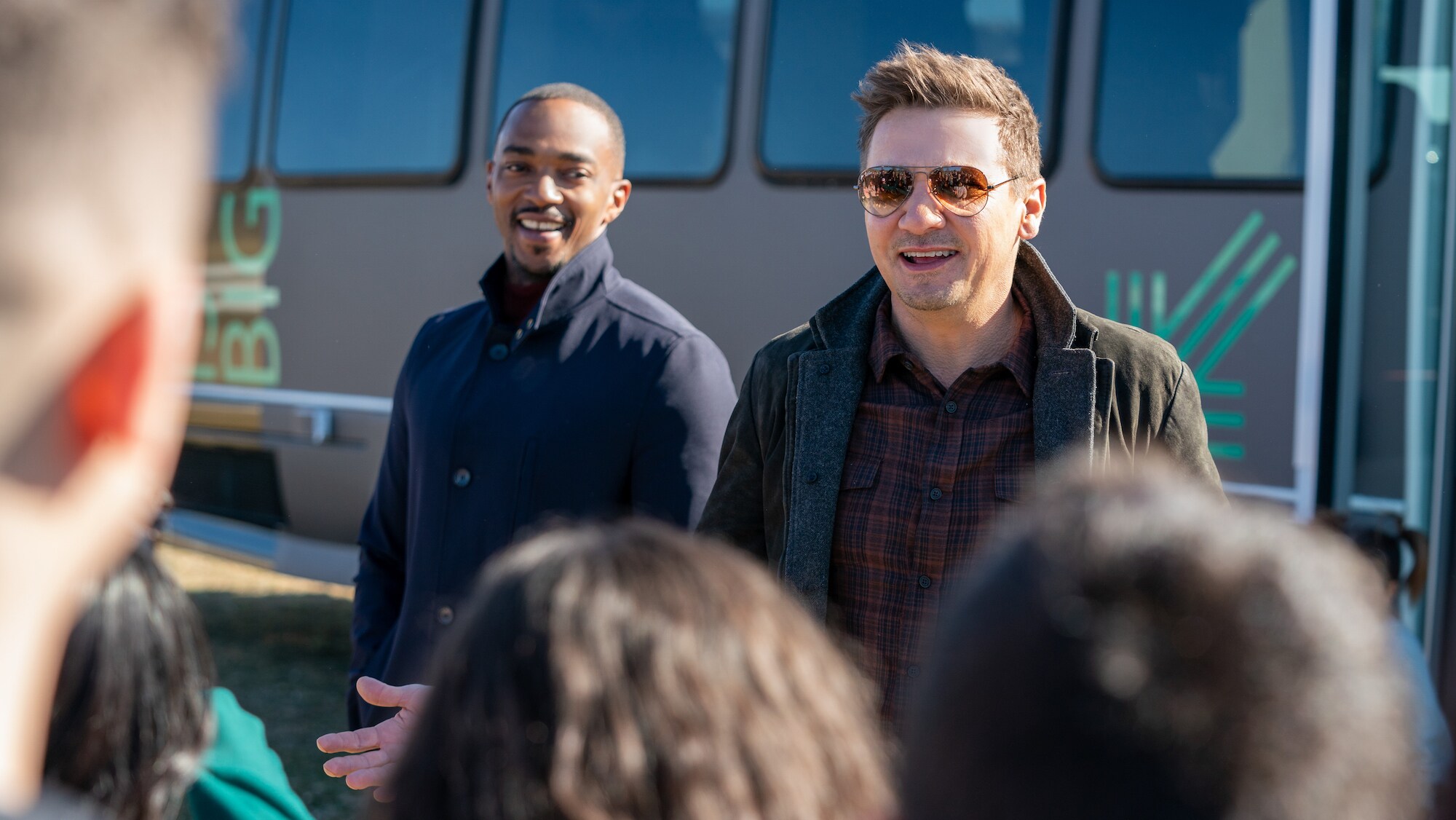 Anthony Mackie and Jeremy Renner greet the crowd at the reveal of the Big Brothers Big Sisters vehicle in Reno, as seen on Disney's RENNERVATIONS.  (Disney/Katrina Marcinowski)