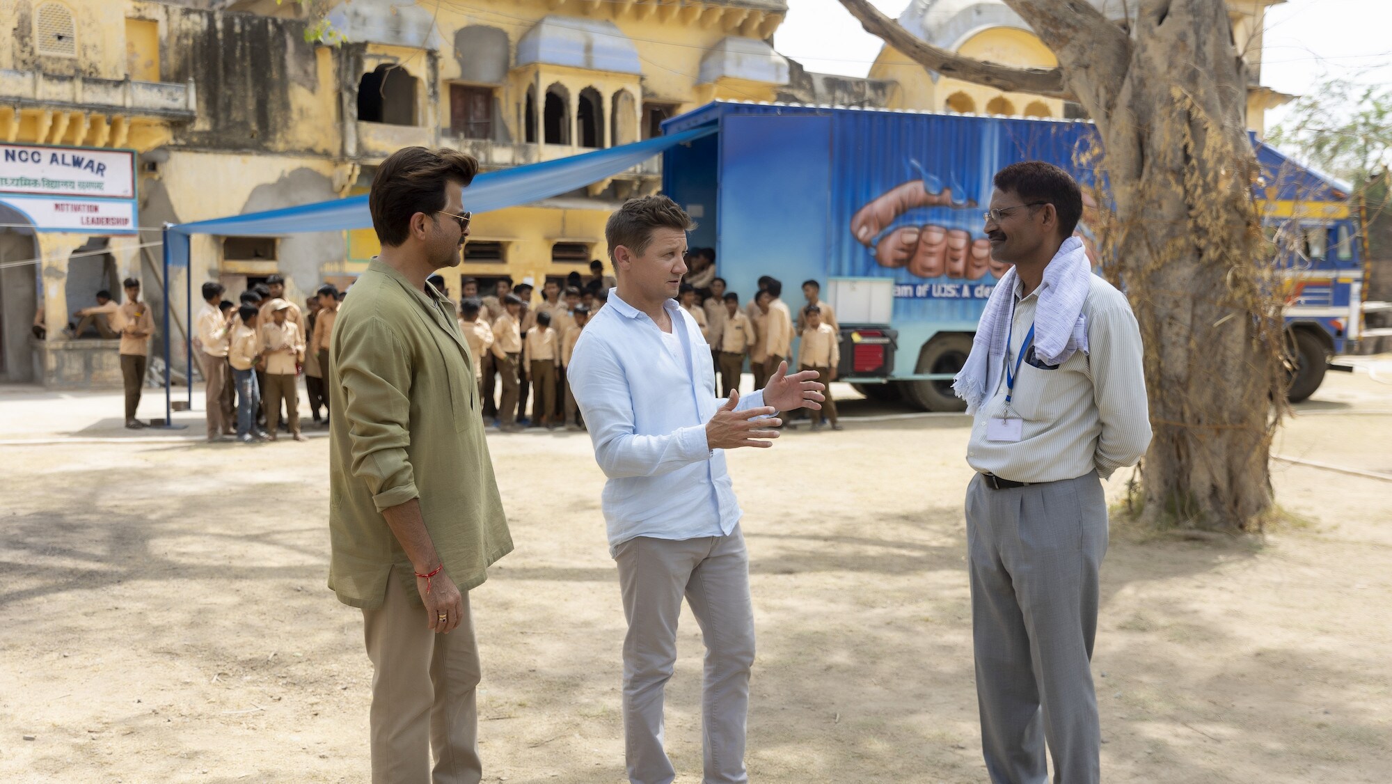 Anil Kapoor and Jeremy Renner speak with Principal Dhanmat Kahn as seen on Disney's RENNERVATIONS. (Disney/Mansi Midha)