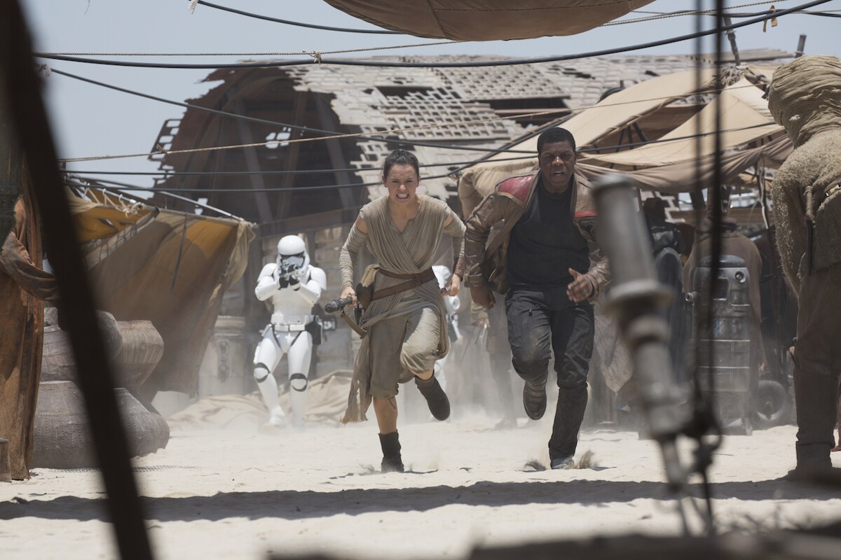 Rey and Finn being pursued by First Order Stormtroopers on Jakku
